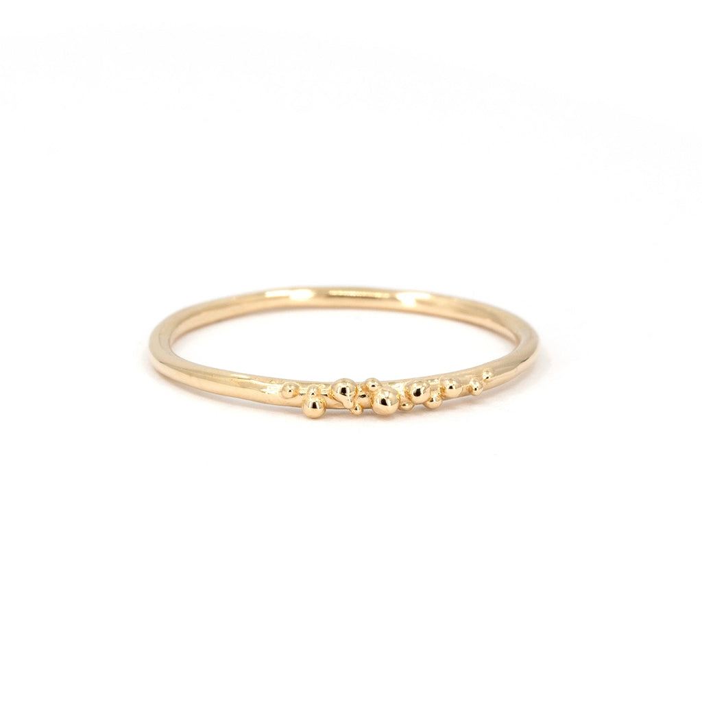 Delicate gold ring featuring an organic arrangement of tiny gold granules along the band. Handcrafted by Meg Lizabet, available at Ruby Mardi in Montreal.