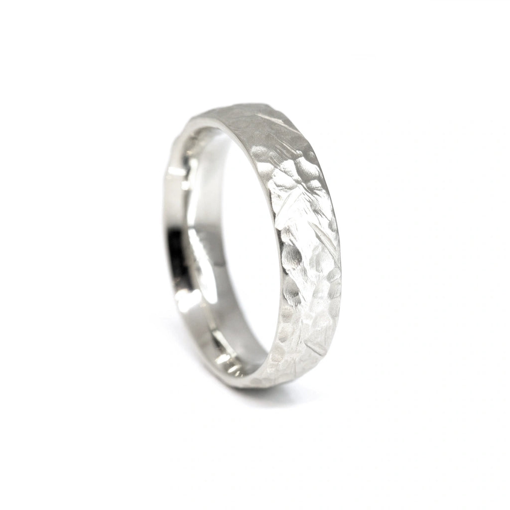 side view of white gold men wedding ring textured band unisex fine jewelry by the artisan jewellery designer shenna from montreal little italy for ruby mardi jeweler