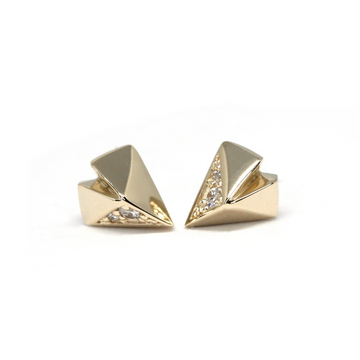 Diamond stud earrings with an edgy style photographed on a white background. The earrings have a funky heart shape and are casted in yellow gold. They have 4 small natural diamonds. This jewel was designed in Montreal by Bena Jewelry. 