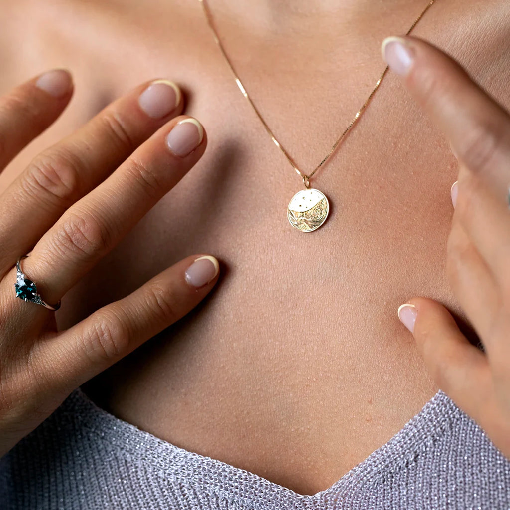 Gold pendant necklace with intricate hand engraving, worn on a model’s neck, Canadian fine jewelry from Ruby Mardi.