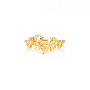 Textured ring by Anouk Jewelry, resembling a laurel crown with a slightly hammered finish and a round natural diamond in bezel setting, available at Ruby Mardi, displayed against a white background.