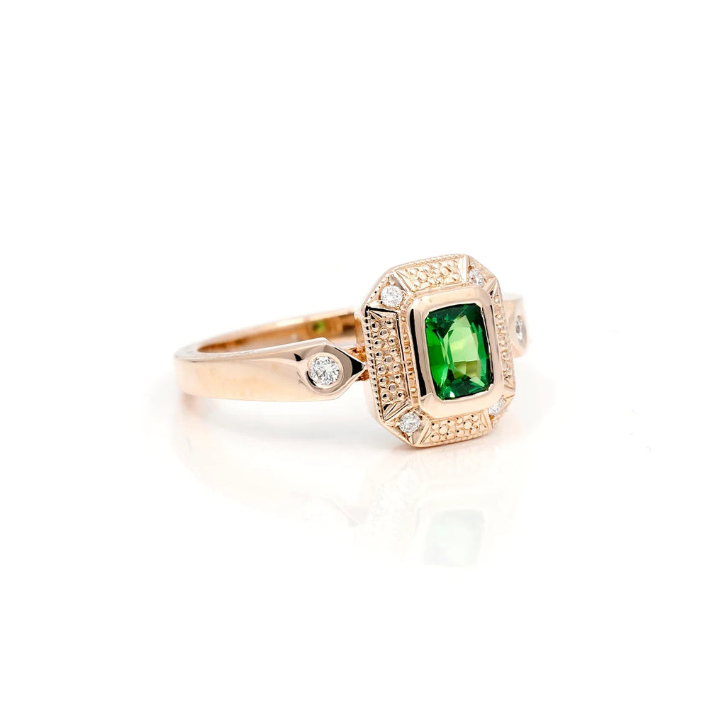 This ring by Deborah Lavery, an independent Canadian designer, is made with a rectangular cut-shaped colored gemstone. This unique jewel is mounted on gold with a bezel setting and accompanied by small, super briallant diamonds. This alternative and magnificent engagement ring is available for sale exclusively at the Ruby Mardi jewelry store in Montreal.