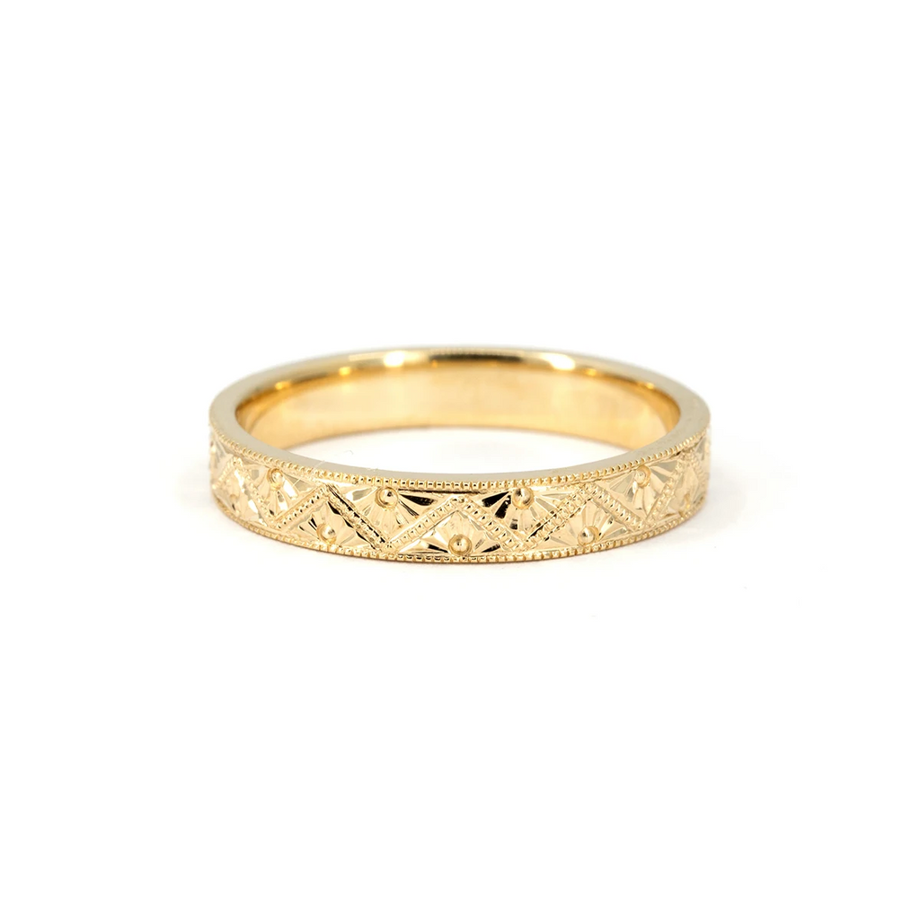14k yellow gold wedding band with intricate hand-engraved Art Deco patterns and milgrain detailing. Designed by Deborah Lavery, available at Ruby Mardi in Montreal.