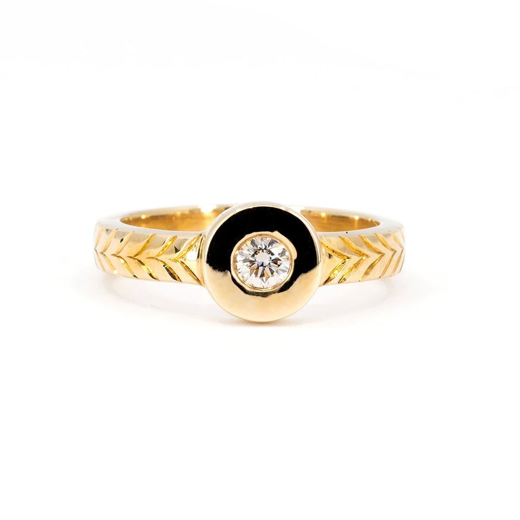 Thick gold signet ring with hand engraved details on the band and a central round champagne diamond. This designer ring from Canadian jewelry designer Savannah Jones is available at Ruby Mardi, the best jewelry store in Canada.