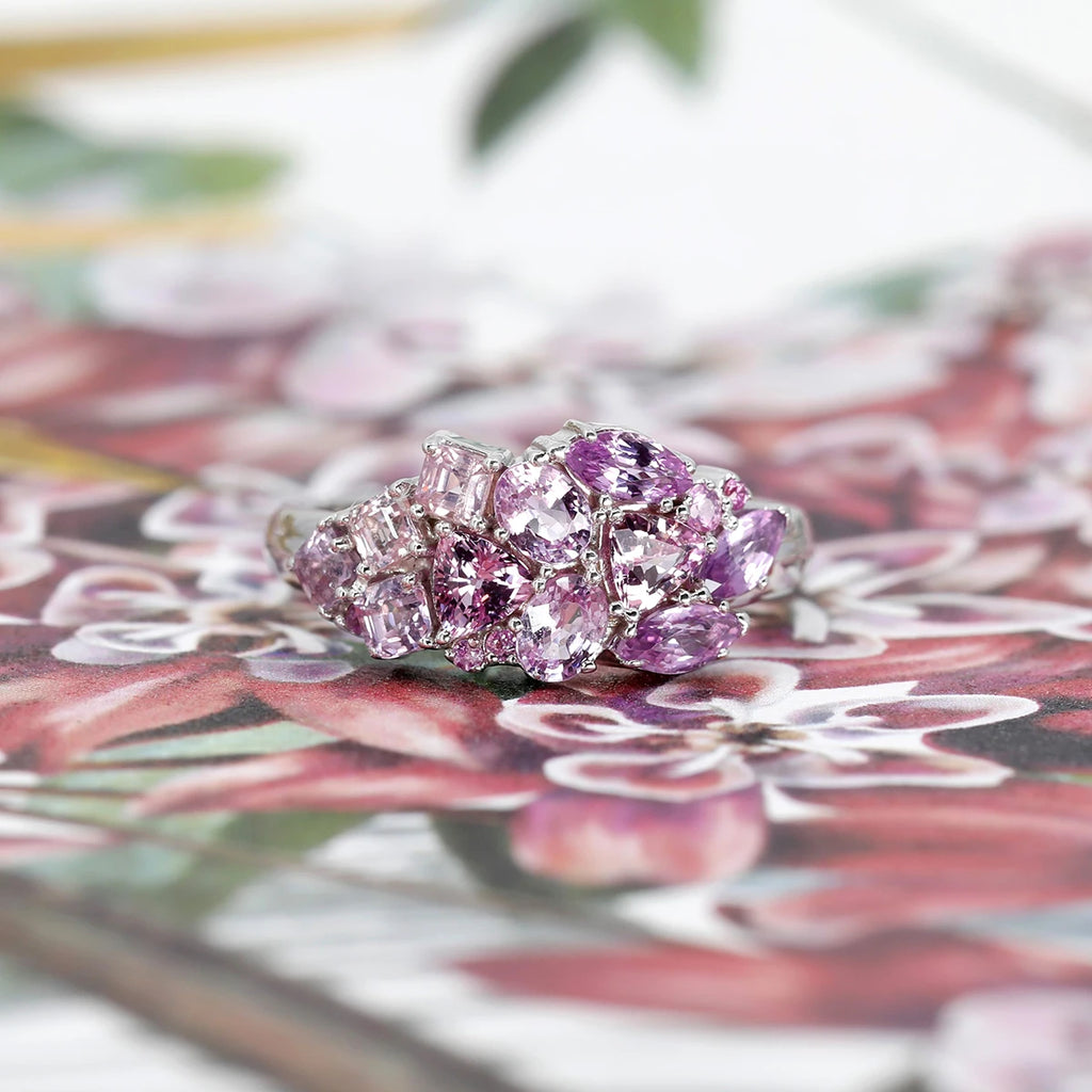 This splendid designer ring is made with pink sapphire with a light purple tint and made with natural colored gems in marquise, trillion or princess shapes and mounted in white gold. This original ring is made in Montreal and is available for sale at the Ruby Mardi jewelry store.