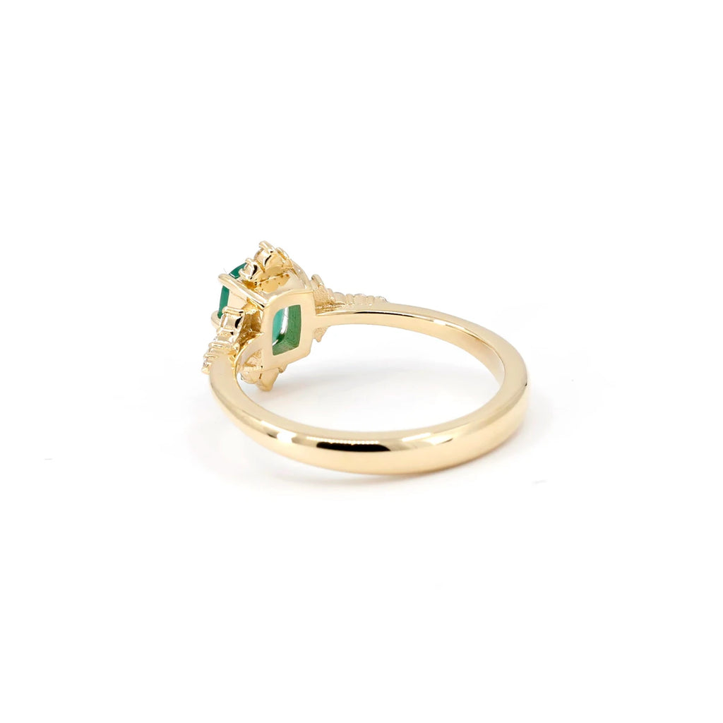 This yellow gold engagement ring is made in Canada by independent designer Oleg Leybman. Mounted on yellow gold, the central emerald is cushion-shaped with several small natural diamonds to enhance the main green gem. The Ruby Mardi jewelry store located in Montreal is pleased to offer for sale this fine jewelry from an independent designer.