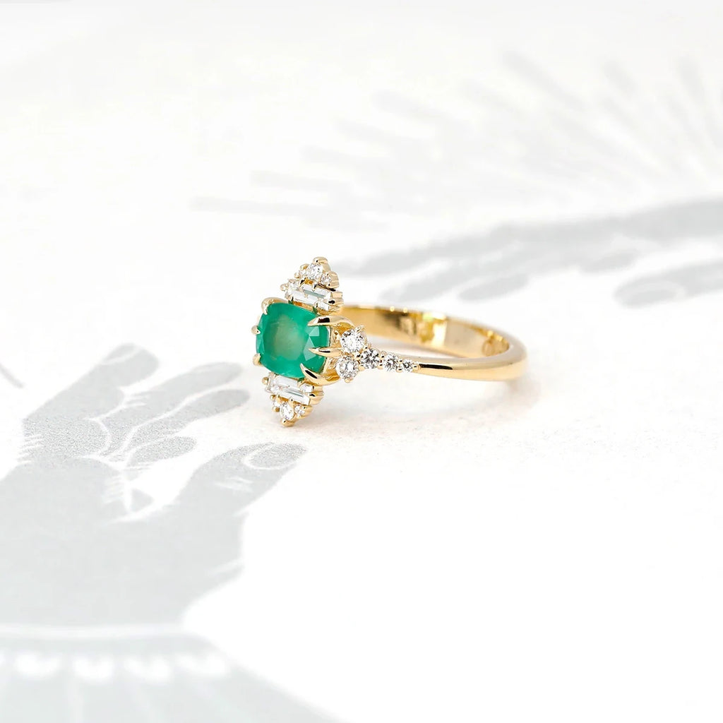 This emerald ring is made with many round and baguette shaped diamonds. Handmade in Canada by independent jewelry designer Oleg Leybman, this wedding ring is one of a kind with a vintage twist. This designer fine ring is available for sale at the Ruby Mardi jewelry store located in Montreal.