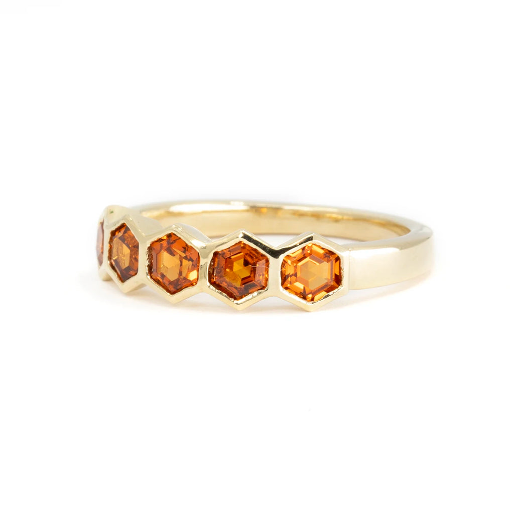 The jewelry designer In the Light of Day presents the Honezcomb ring in a closed setting with vivid orange spessartite garnets. Available for sale by the Ruby Mardi jewelry store in Canada, specialist in one-of-a-kind jewelry from independent artisan jewelers.