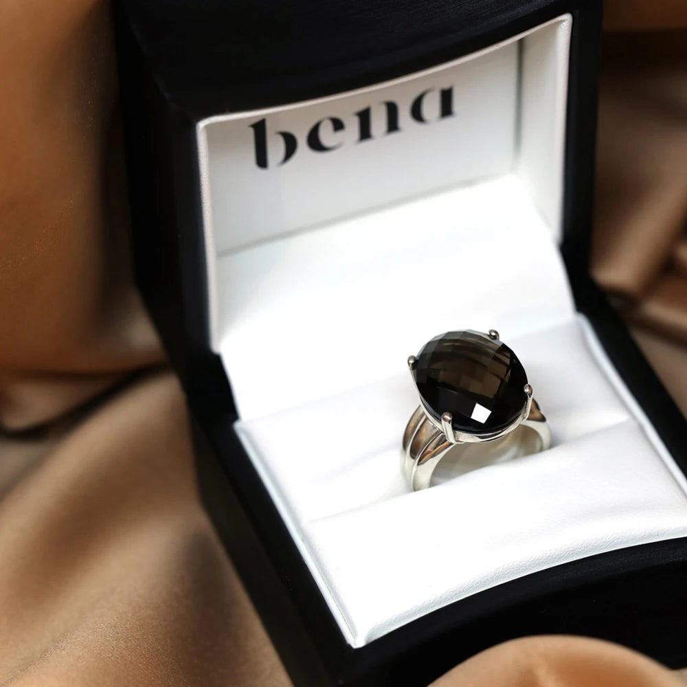 This ring made of silver with an oval-shaped smoky quartz is an edgy creation made by independent jewelry designer Bena Jewelry in Montreal, in collaboration with the Ruby Mardi jewelry store.