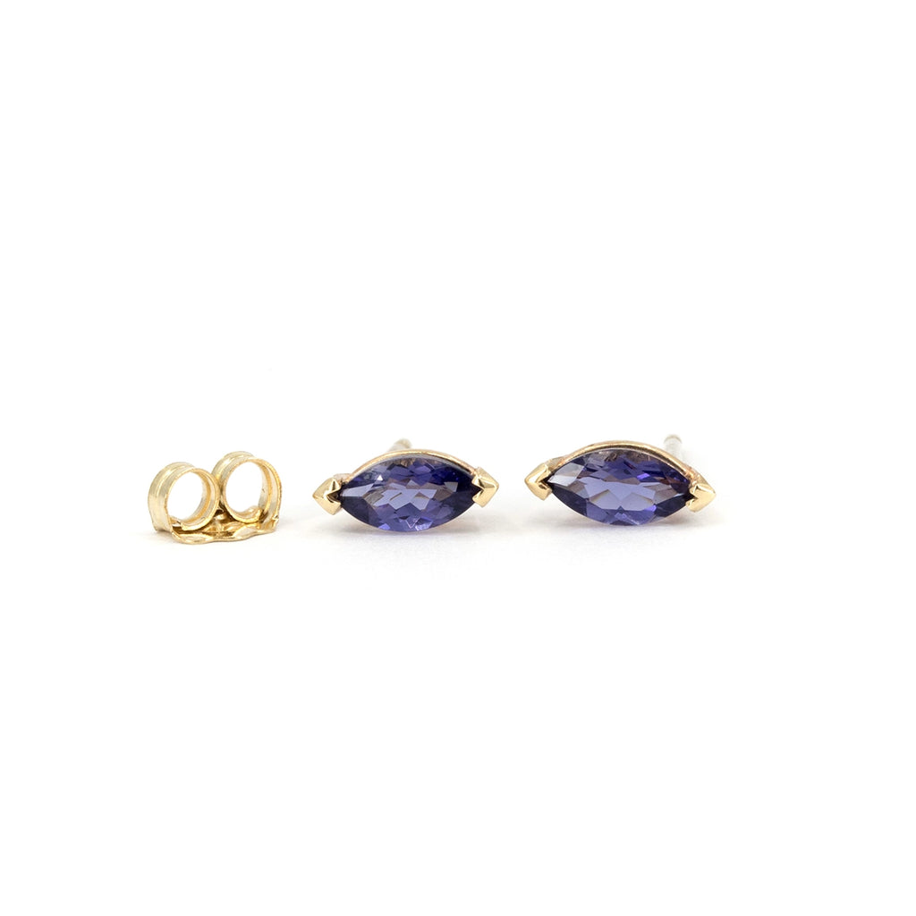 Natural marquise-cut iolite stud earrings in 10k yellow gold, shown from the front with matching gold backs on a white background, available at Ruby Mardi in Montreal.