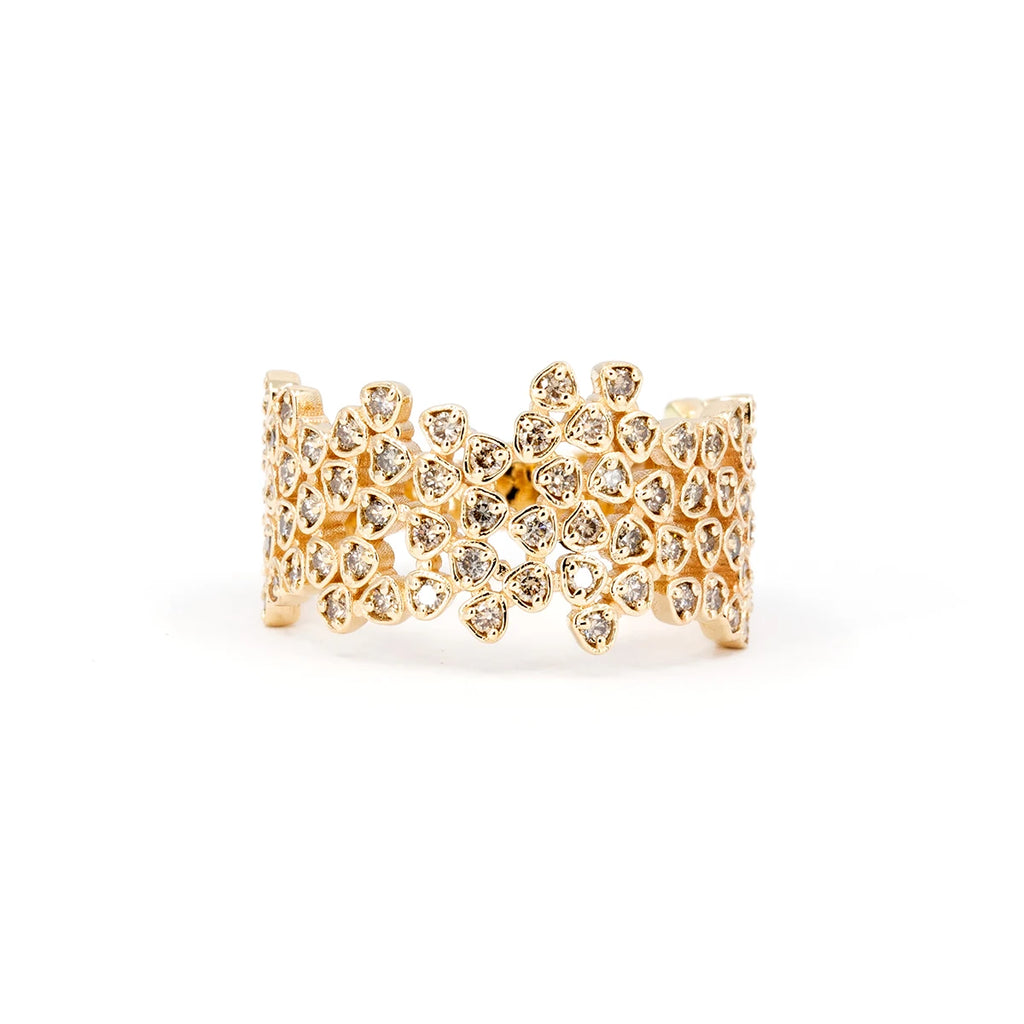 This stunning yellow gold Lace ring with champagne colored diamonds is handmade by Canadian artisan jeweler Oleg Leybman. Made with small bezel settings, these brown colored gems are natural. This fine jewelry and engagement ring is available at Ruby Mardi, the best jewelry store in Montreal and Canada for independent designer jewelry.