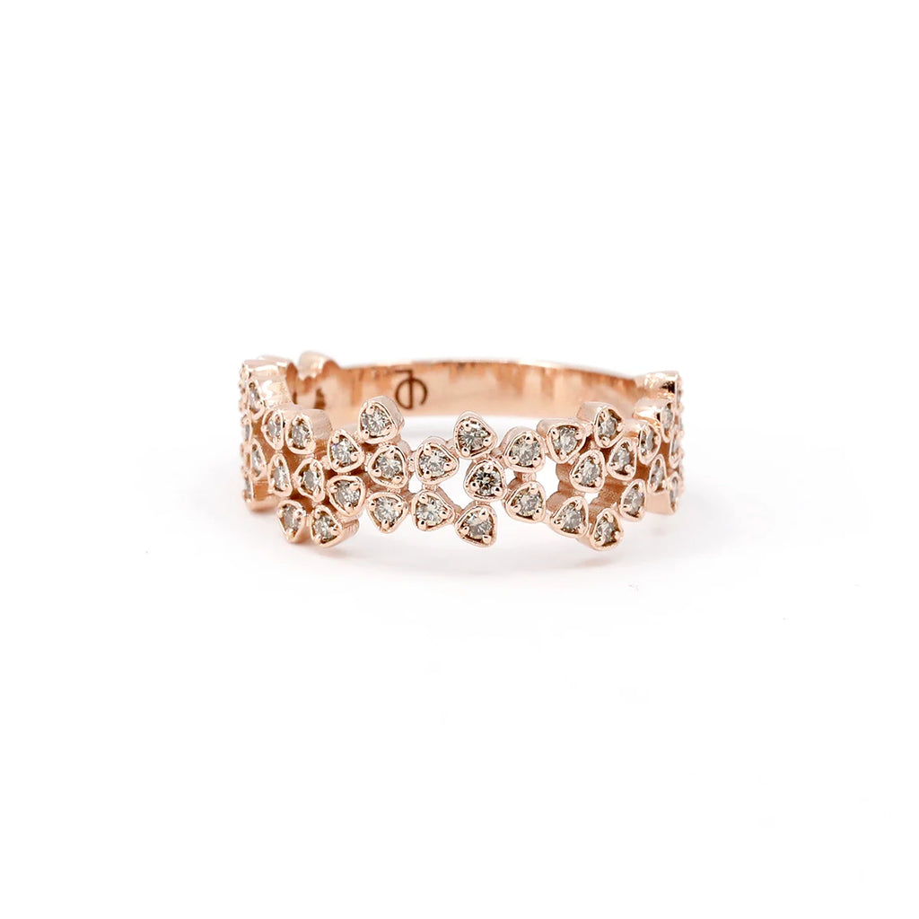 This stunning designer ring is crafted in rose gold with small champagne diamonds, which are natural brown colored gems. Handcrafted by Canadian jewelry designer Oleg Leybman, this statement piece of jewelry is one of a kind and is available at the Ruby Mardi jewelry store located in Montreal and specializing in engagement rings and other bridal jewelry made by independent artisans.