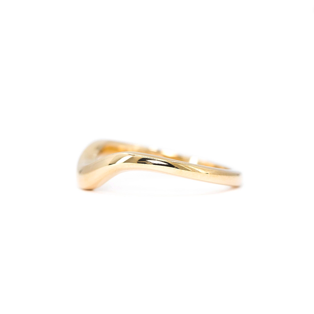 Stackable curved gold ring designed by Yuliya Chorna, part of Ruby Mardi’s Montreal collection of Canadian fine jewelry and modern wedding bands.