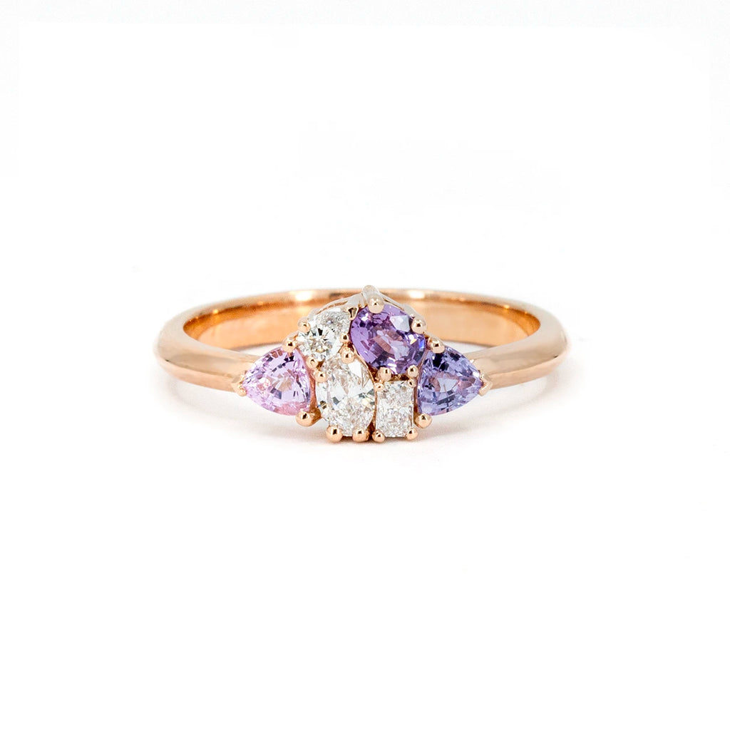 A delicate 14k rose gold cluster ring featuring three light purple sapphires and three lab-grown diamonds, designed by Ruby Mardi. Its compact and romantic design evokes a vintage-inspired elegance. Photographed from the front on a white background.