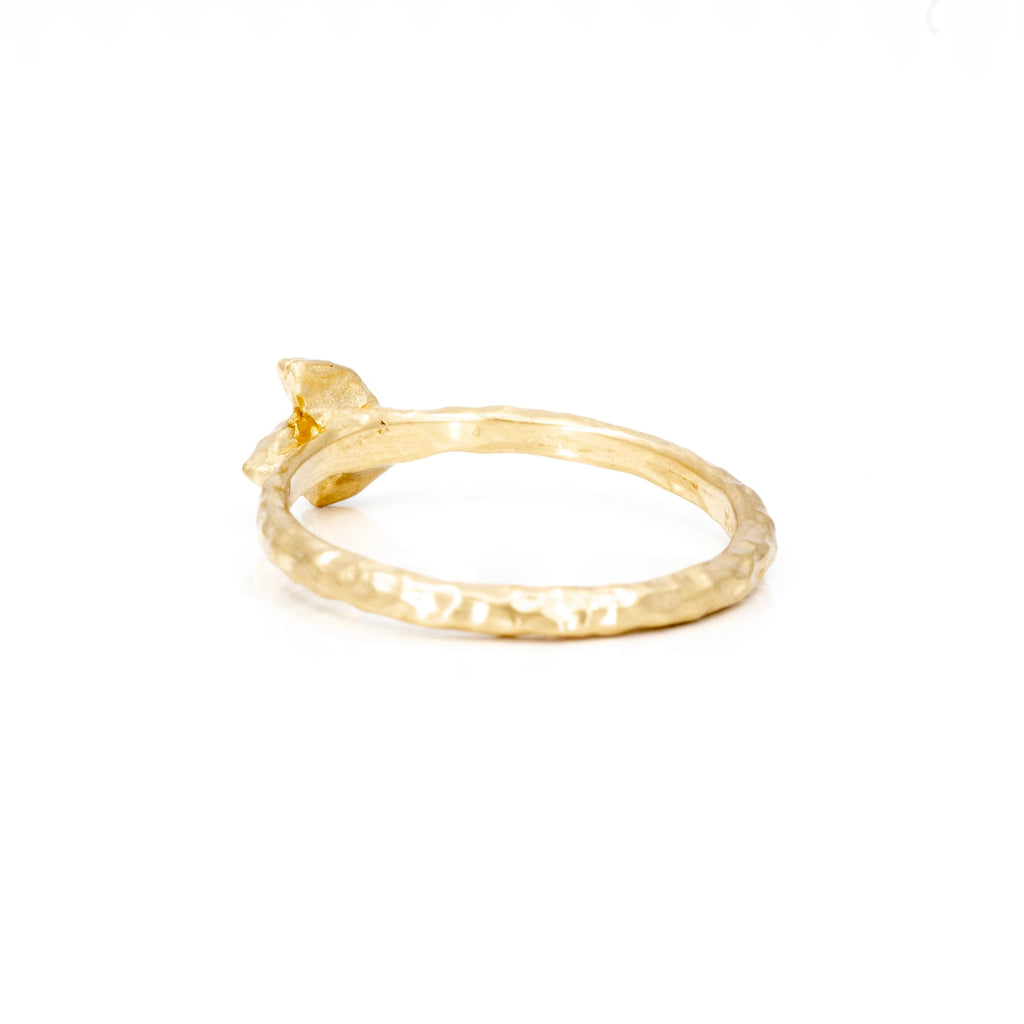 One-of-a-kind gold wedding band with an organic texture is photographed on white background and is seen from the back. This yellow gold ring is an alternative bridal jewelry piece that can also be worn as a right hand ring or as an everyday jewel. It was handmade in Toronto by Anouk Jewelry, and is available only at boutique Ruby Mardi in Montreal.