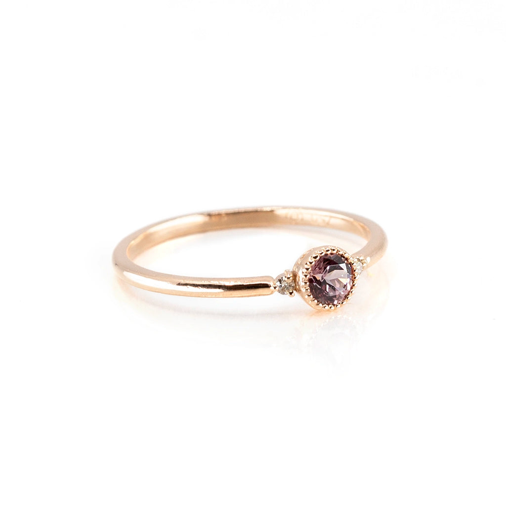 Delicate and feminine engagement ring in 18 karat gold with a central malaya garnet and 2 natural Canadian diamonds. The ring was handmade by independent jewellery brand Atelier Emige and is available at the best jewelry store in Canada, Ruby Mardi.