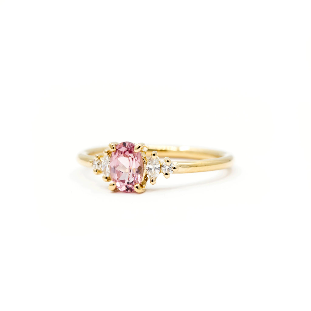 Yellow gold engagement ring with oval Malaya garnet and marquise side diamonds, handmade by Maksym in Montreal for Ruby Mardi, fine jewelry store in Canada.