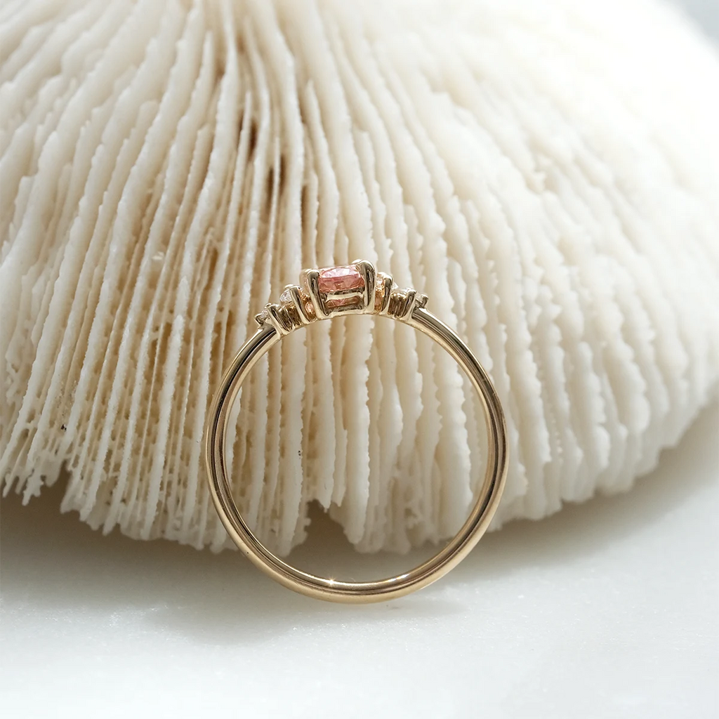 Back view of Malaya garnet engagement ring with sculptural yellow gold setting, pink center stone and engraved detailing, designed by Maksym, available at Ruby Mardi, Montreal.