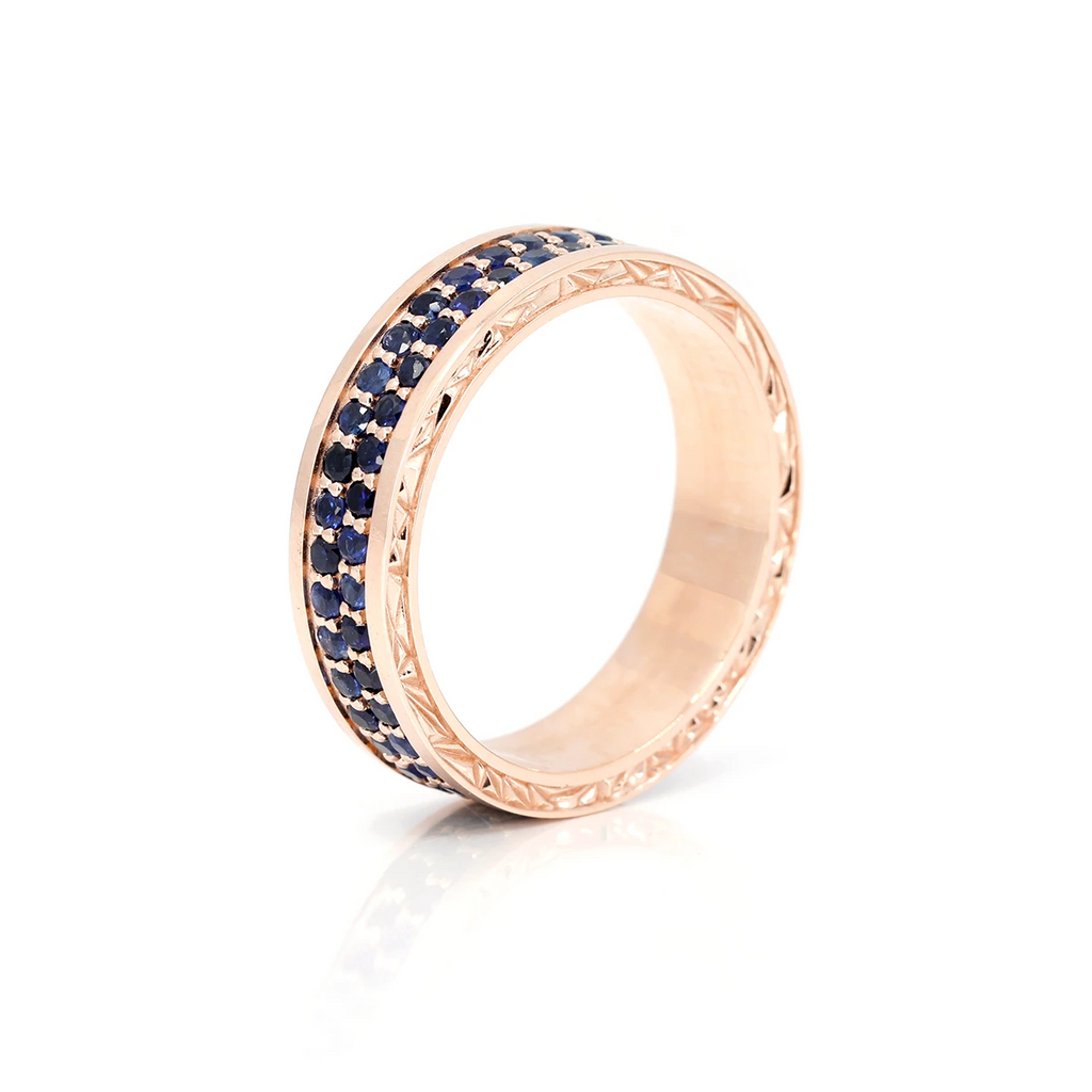This men's ring in pink is paved with royal blue sapphire. The edgy bridal jewelry is made in pink and beautiful natural gemstone. Handcrafted by designer Bena Jewelry, specialist in contemporary bridal jewelry, in partnership with Ruby Mardi jewelry store in Montreal.