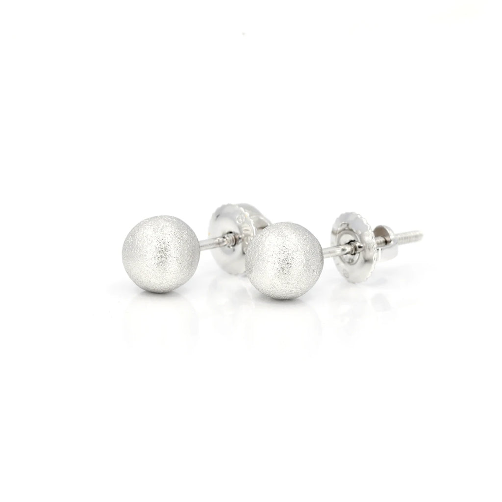 Independent jewelry designers VCL based in Montreal present white gold studs with handmade satin texture and ball shape. These essential and classic jewels are available for sale at the Ruby Mardi jewelry store, which is a space and gallery of jewelry from fine Canadian jewelers.