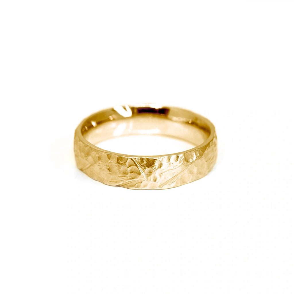 Textured yellow gold wedding band for men, or gender neutral wedding ring, handmade in Montreal by independent jeweller Sheena Purcell. Available at Ruby Mardi, the best jewelry store in Montreal.