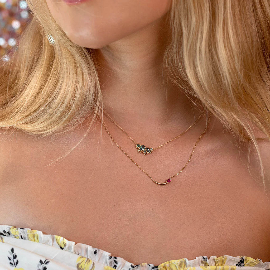 Model wearing layered gold necklaces, featuring a Montana sapphire cluster pendant by Meg Lizabet and Ruby Mardi, unique Canadian jewelry design.