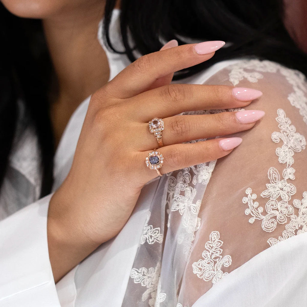 Young woman wearing alternative engagement rings made in Canada. The center gem of this bridal ring is made with a gray spinel and a diamond halo. Made by independent jewelry designer Déborah Lavery this bridal jewelry is one of a kind and alternative.
