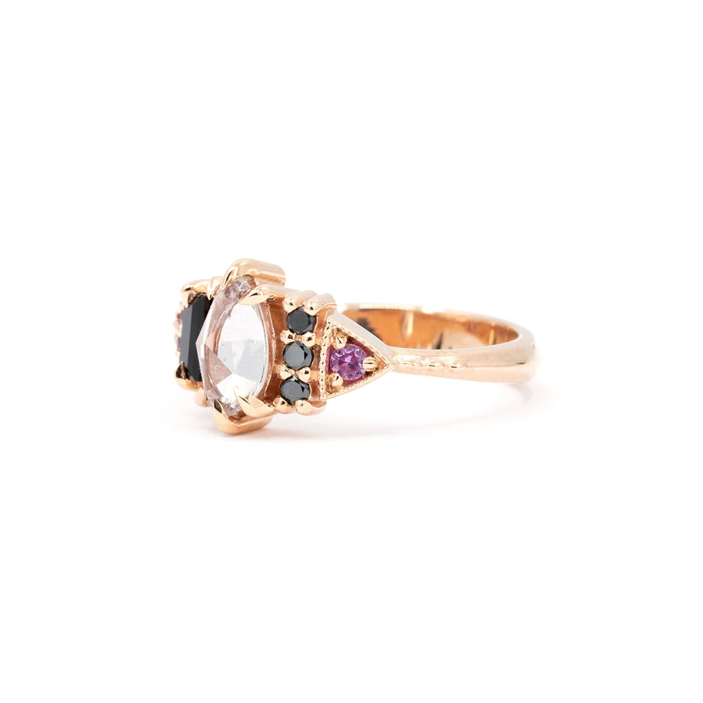 Artistic close-up of a 10k rose gold ring with pink sapphire and black spinel by Nadia Werchola. Unique Canadian jewelry at Ruby Mardi.
