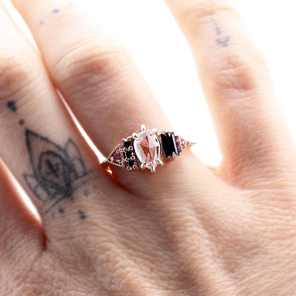 Handcrafted pink and black gemstone ring by Nadia Werchola, worn on the hand. Fine designer jewelry available at Ruby Mardi in Montreal.