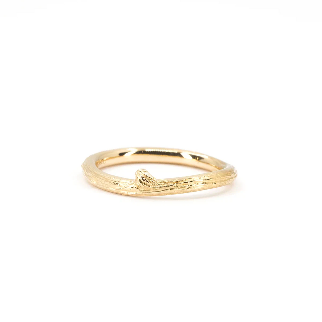 Fine yellow gold ring designed by Meg Lizabet, featuring an organic branch texture with a small raised knot motif. Minimalist, nature-inspired jewelry handcrafted in Montreal and showcased at Ruby Mardi.