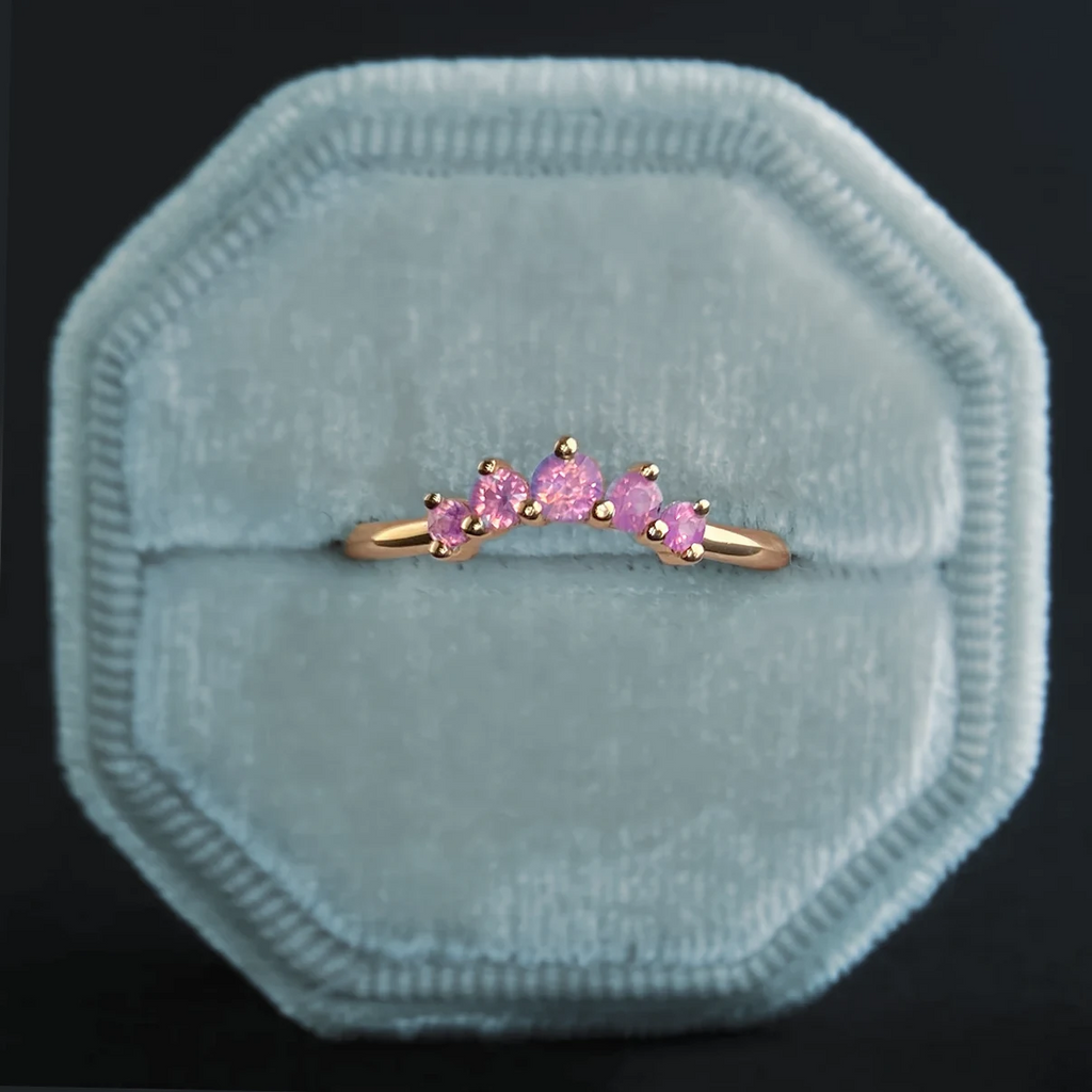 Pink sapphire contour ring "Bagatelle" by Emily Gill, set in 14k yellow gold and displayed in a pale blue velvet ring box. Handmade in Canada, available at Ruby Mardi in Montreal.