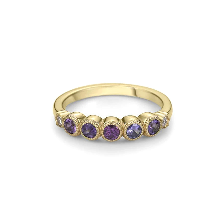 Discover the splendor of this half eternity wedding band, featuring natural purple, pink and purplish sapphires, beautifully arranged in yellow gold. A masterful work from independent designer Bramston Goldsmithing in Canada, where every detail demonstrates the commitment to excellence. Available at Ruby Mardi of Montreal, the jewelry store specializing in unique, handmade bridal jewelry.