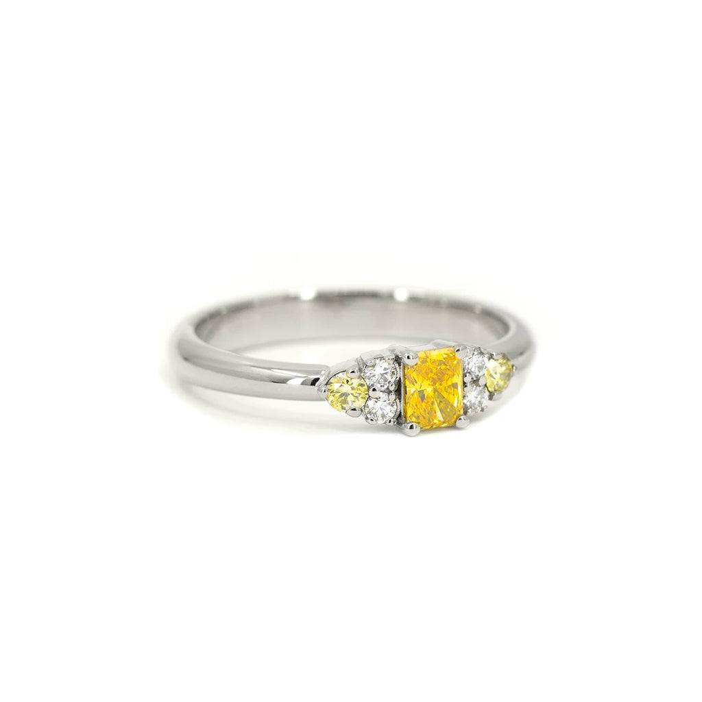 Side view of radiant yellow lab-grown diamond ring with canary yellow and white diamond accents in 10k white gold – Ruby Mardi Montreal.