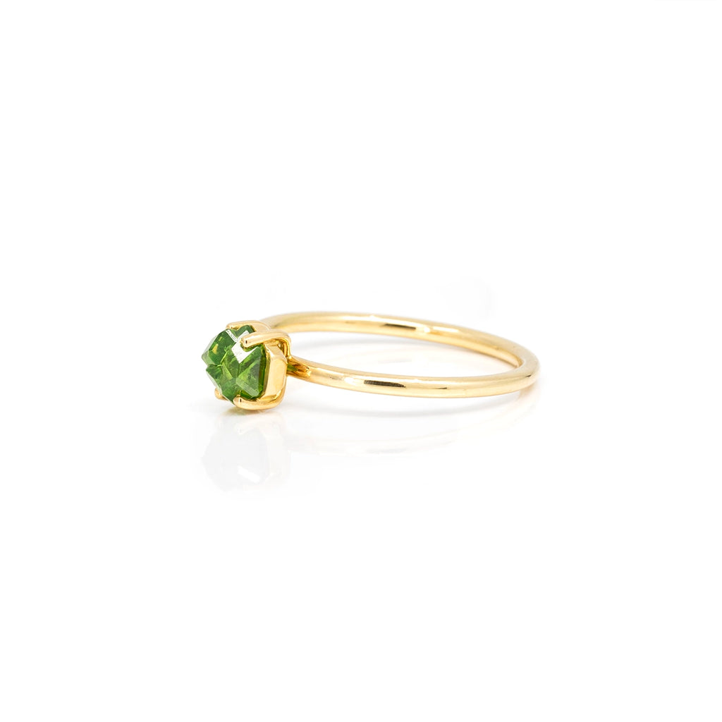 Rough demantoid garnet crystal from Quebec set in 18k yellow ring by jeweller François Charest. One-of-a-kind alternative engagement ring or right hand ring only available at jewelry store Ruby Mardi in Montreal, and seen here photographed on a white background.