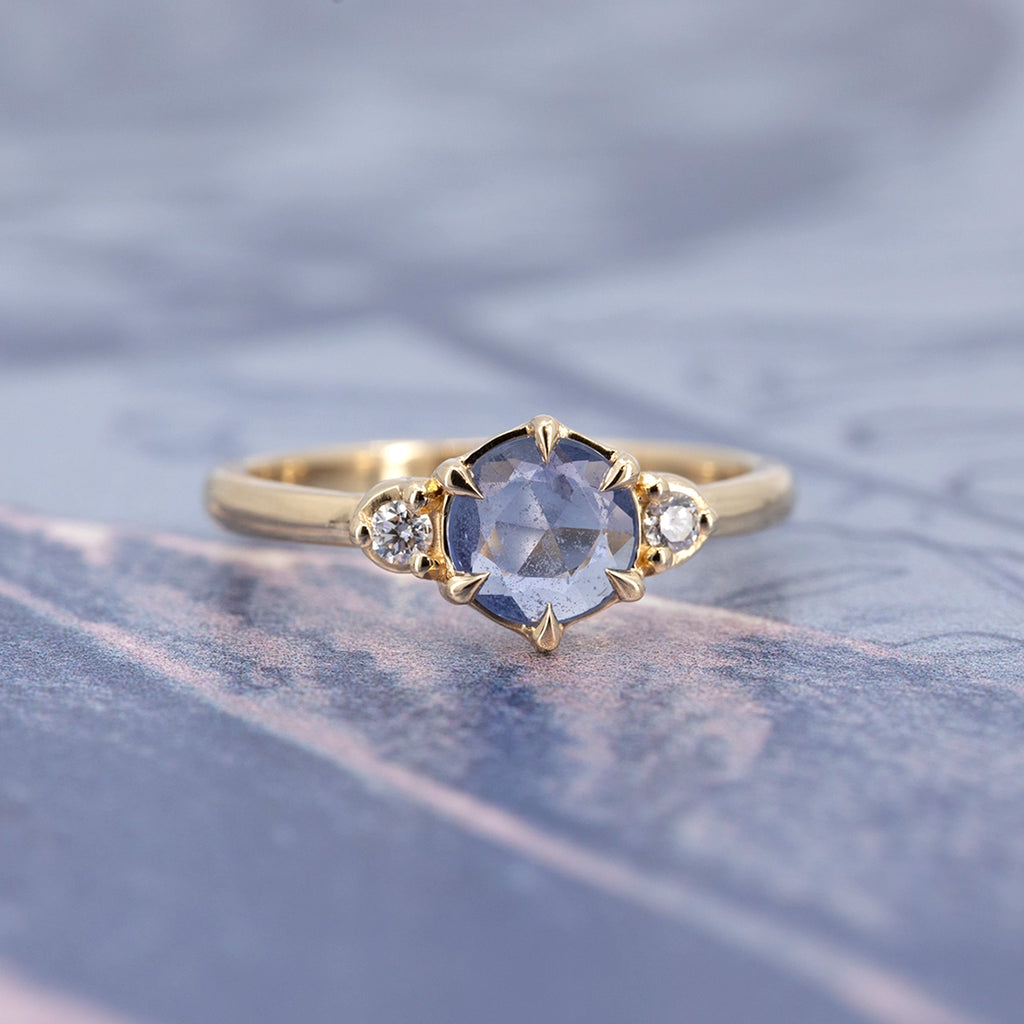 Natural rose-cut blue sapphire engagement ring with two round diamonds in 14k yellow gold, fine jewelry by Yuliya Chorna at Ruby Mardi Montreal, Canada.