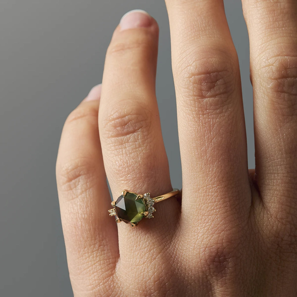 Close-up of rose-cut green sapphire ring with diamond side stones in yellow gold, unique alternative engagement ring design, worn on finger, made by Fluid Jewellery, Ruby Mardi, Montreal Canada.