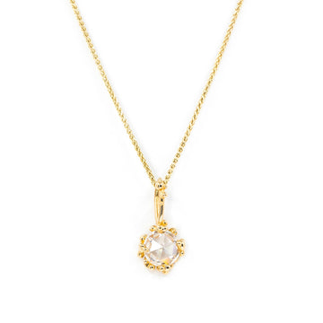 Rose cut moissanite pendant in 14k yellow gold by Meg Lizabet, featuring granulated prongs and a delicate gold chain. Fine jewelry handmade in Montreal, available at Ruby Mardi.