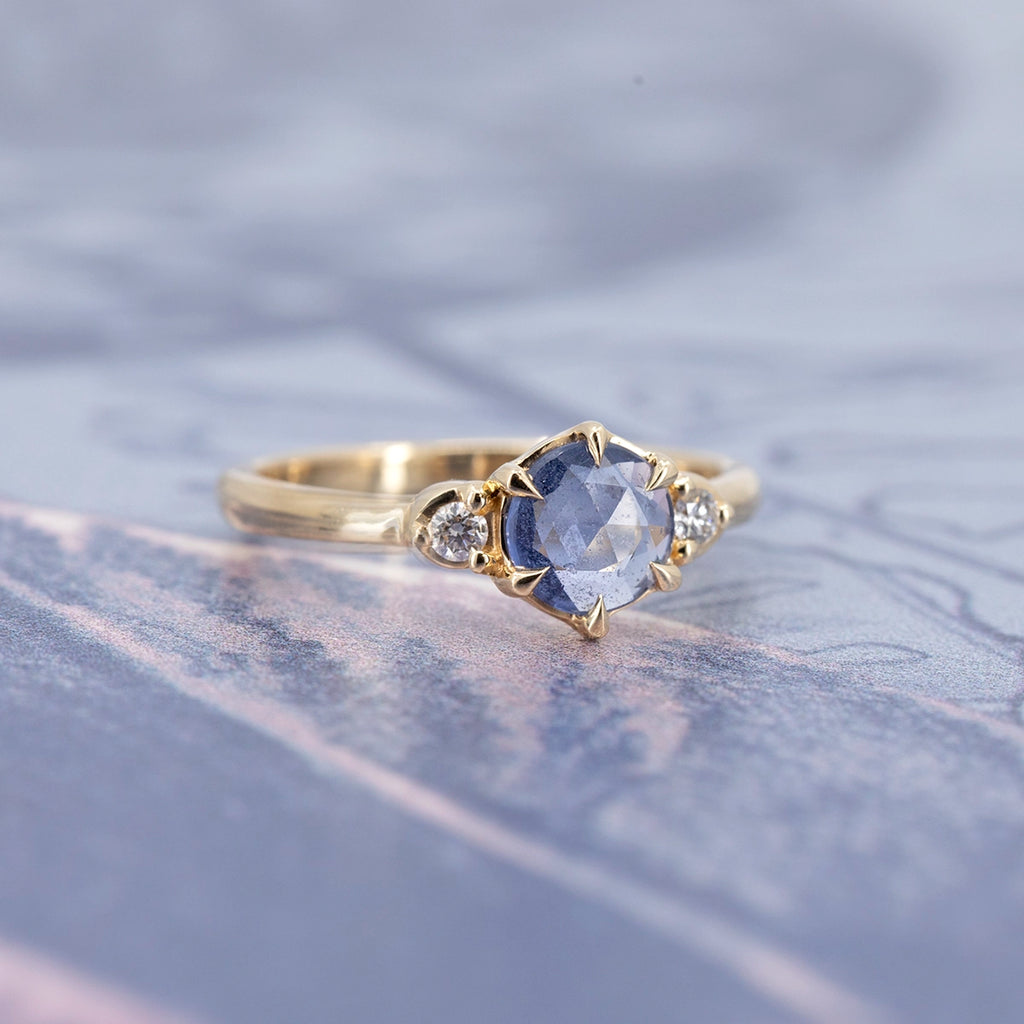 One-of-a-kind rose-cut blue sapphire and diamond engagement ring in solid yellow gold, designed by Yuliya Chorna and photographed at Ruby Mardi Montreal.