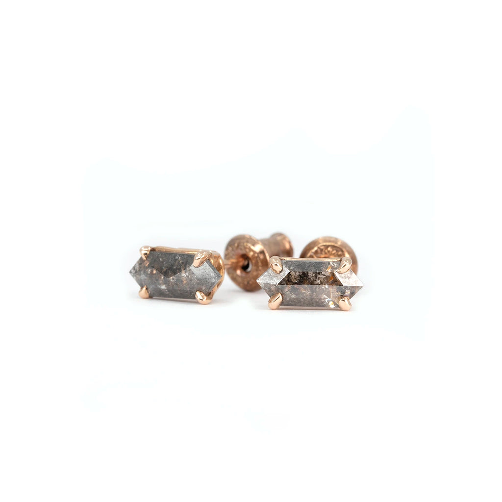 Close-up of salt and pepper diamond stud earrings in rose gold, handcrafted by Canadian designer Emily Gill. Fine jewelry photographed on a white background for Ruby Mardi.