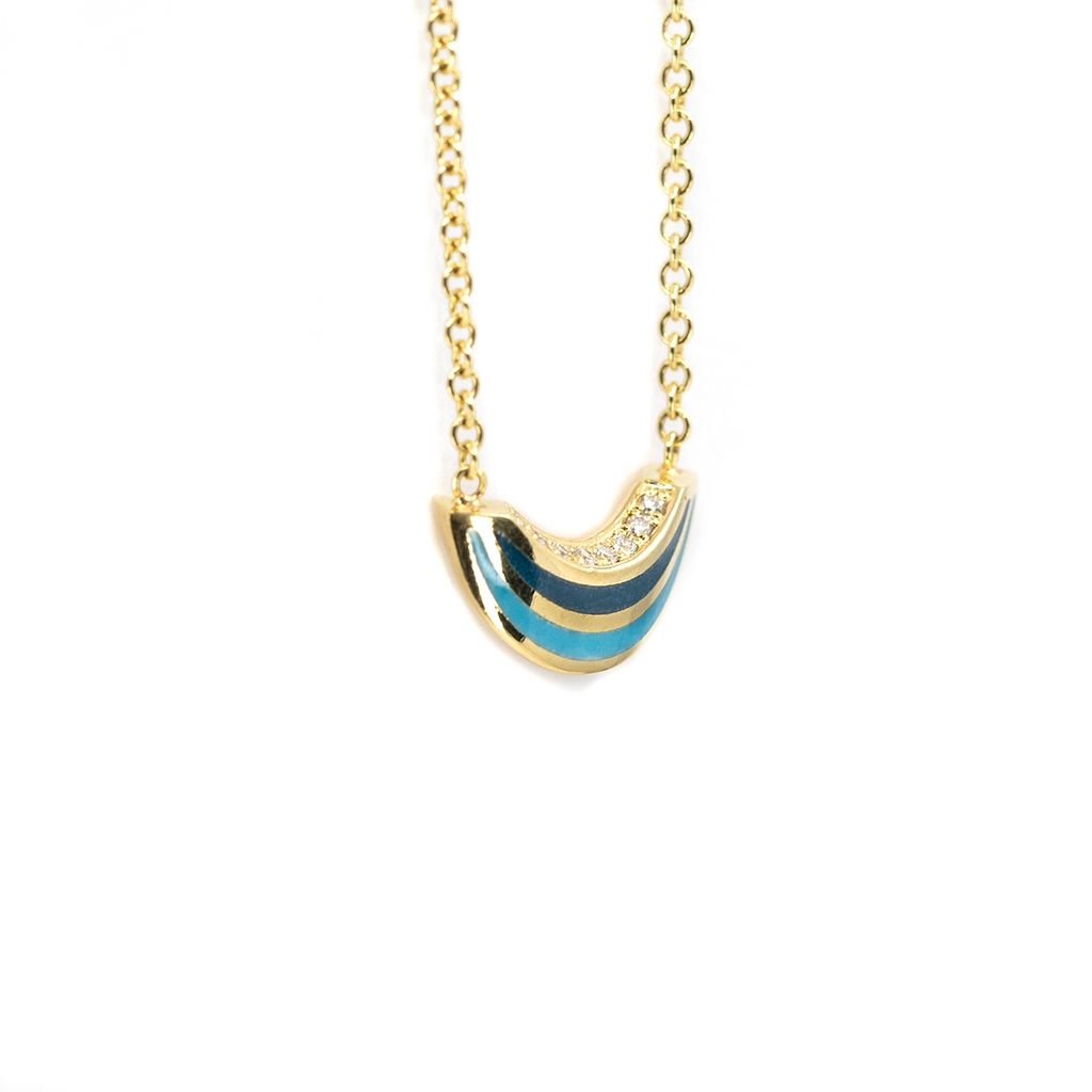 Side view of the Emily Gill enamel pendant necklace in 14k yellow gold with blue enamel and diamonds, handcrafted and available at Ruby Mardi in Montreal.