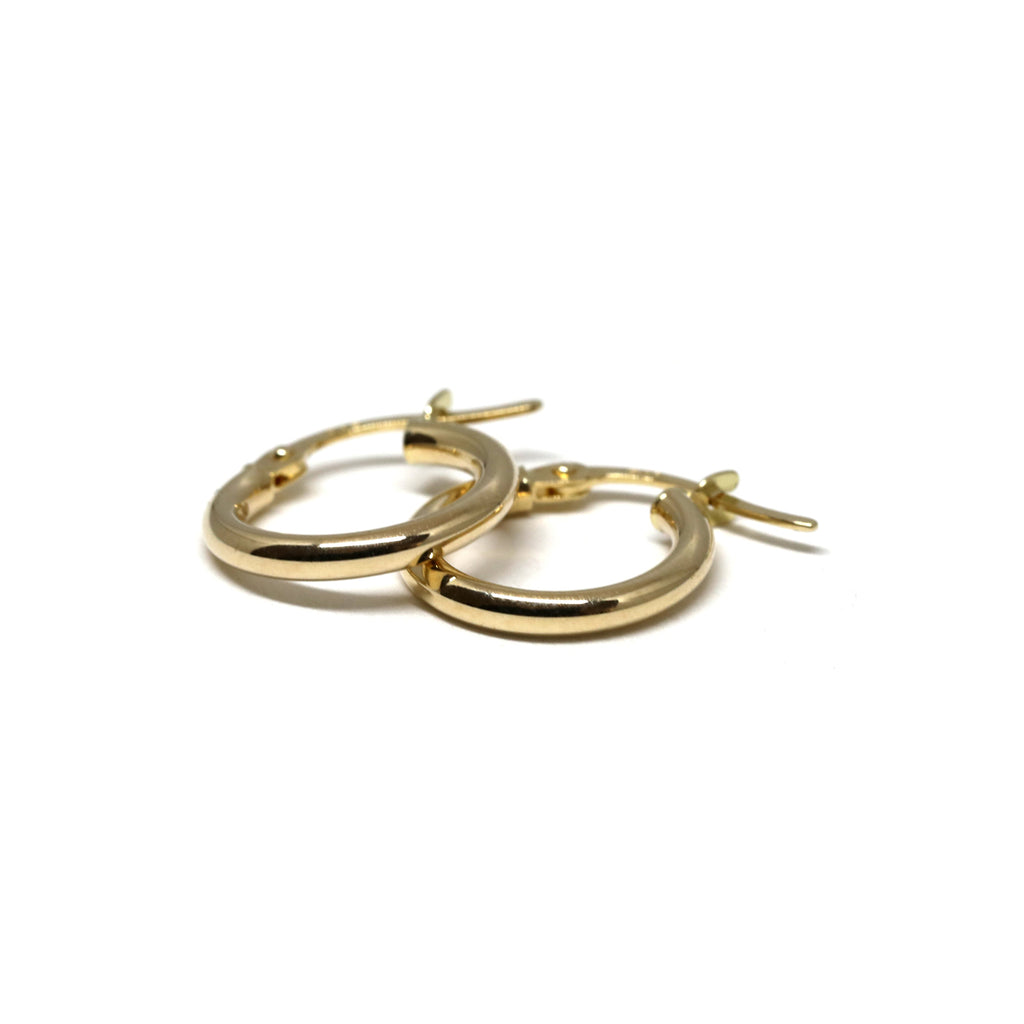 Small 14k yellow gold hoop huggie earrings on a white background. Ruby Mardi offers timeless jewelry classics that you will love to wear for any occasion. We also offer One-of-a-kind designer fine jewelry in Montreal. Find gemstone earrings, statement rings, engagement rings, right hand rings and more at our jewelry store in Little Italy. We also offer custom jewelry services.