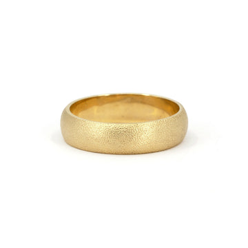 Textured gold wedding band with a soft satin finish, handcrafted for a timeless and organic look. Available at Ruby Mardi, Montreal’s fine jewelry gallery.