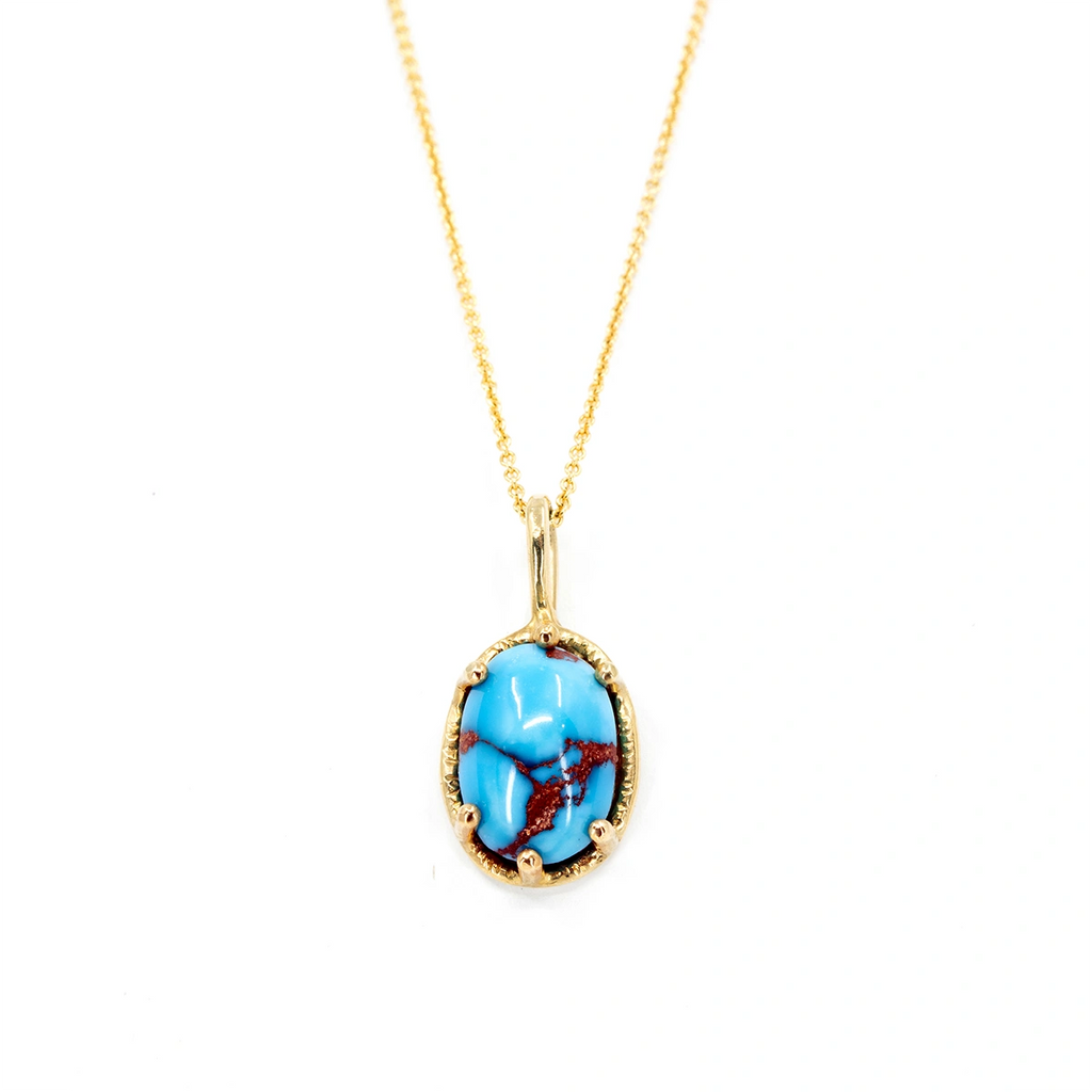This gold pendant with a natural turquoise gemstone is made by independent jewelry designer Sheena Purcel. This fine piece of jewelry made in Canada is a one-of-a-kind creation on sale at the Ruby Mardi jewelry store, a Montreal jewelry gallery of artisan jewelers