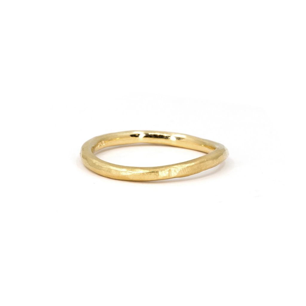 A twisted, organically shaped 2mm-wide gold band with a subtle hammered texture, designed by Sheena Purcell and available at Ruby Mardi in Montreal, an independent jewelry store that offers the most unique designs in town.