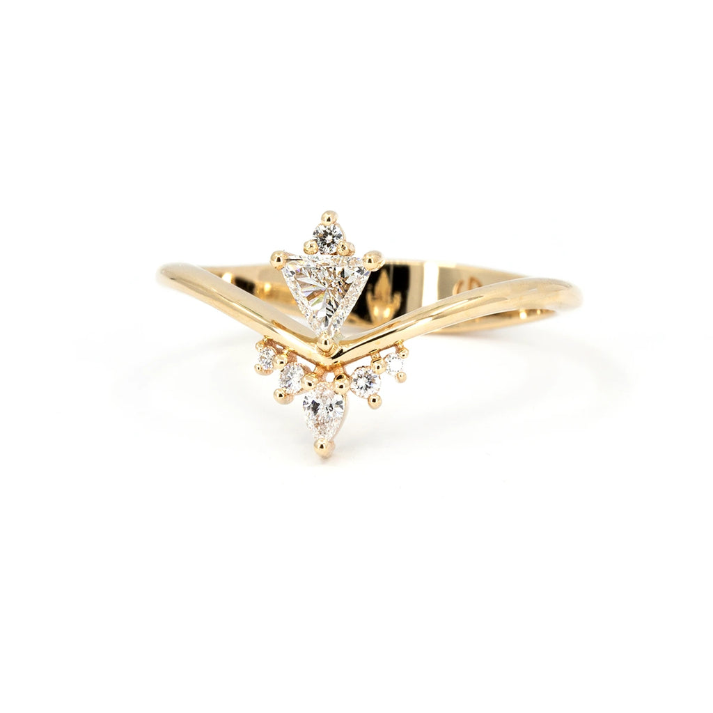 Asymmetrical 14k gold ring featuring trillion, pear, and round diamonds, designed by Oleg Leybman. Studio shot on white background. Available at Ruby Mardi in Montreal.