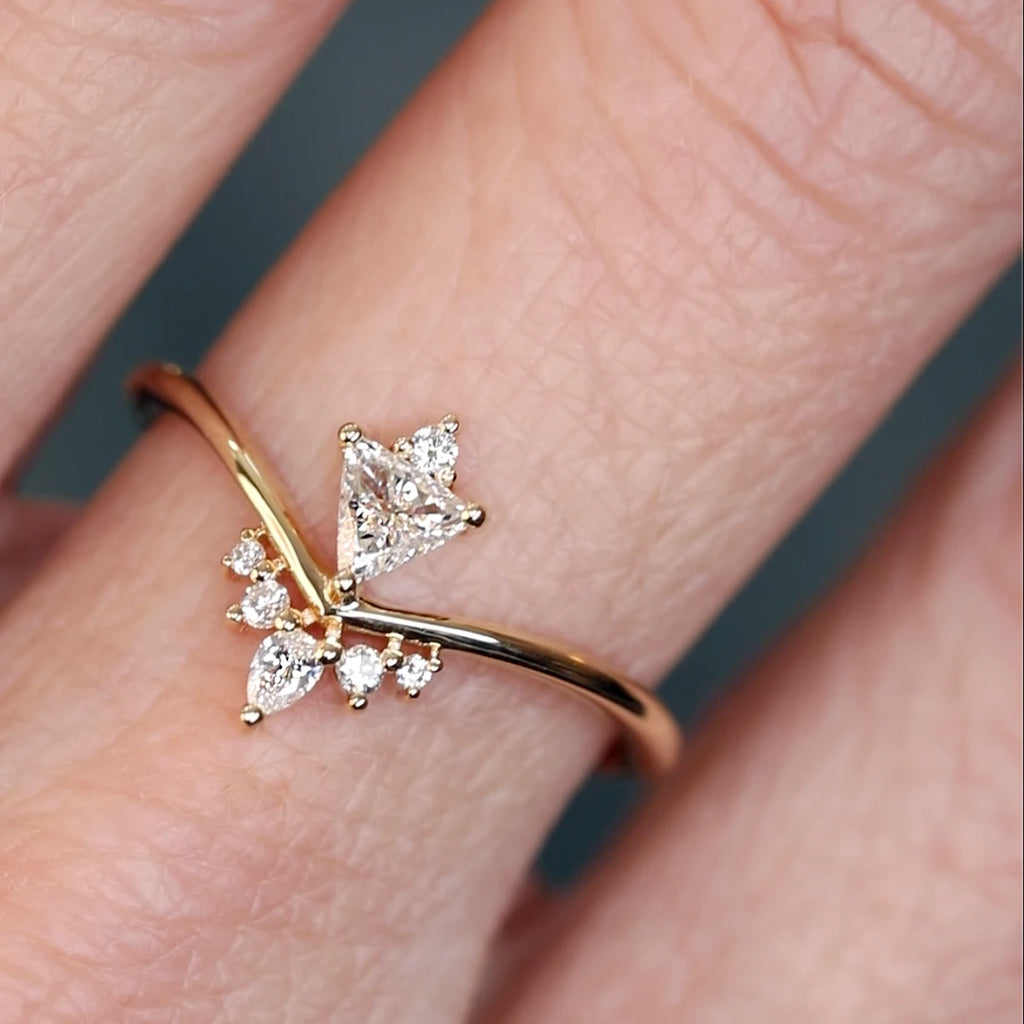 Asymmetrical 14k gold ring with trillion, pear, and round diamonds, designed by Oleg Leybman. Worn on hand. Available at Ruby Mardi in Montreal.