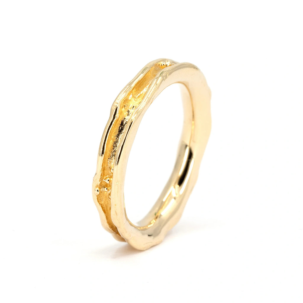 Unique concave wedding band in 14k yellow gold with organic sculpted texture, handcrafted by Meg Lizabet for Ruby Mardi. Photographed on white background.