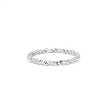 Close-up of a twisted white gold ring on a white background. The minimalist band features a rope-like texture, handcrafted in 14k yellow gold. Unique handmade jewelry available at Ruby Mardi, Montreal.