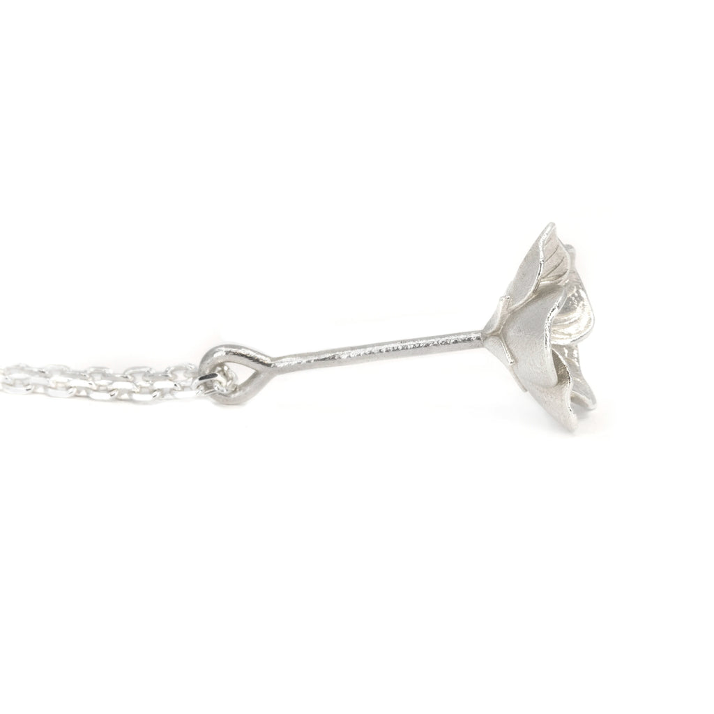 Side view of the white gold wood sorrel pendant by Fleurs Sauvages Qc, showing the long stem and downward-facing Oxalis flower. Handmade botanical necklace available at Ruby Mardi in Montreal.