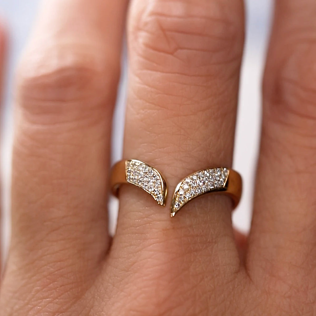 Hand wearing a V-shaped diamond band in solid 10k yellow gold by Canadian jeweller Nadia Werchola. The front of the ring is fully pavé-set with lab-created diamonds, creating a bright, continuous shimmer. Photographed up close to highlight the open design and bold contour.